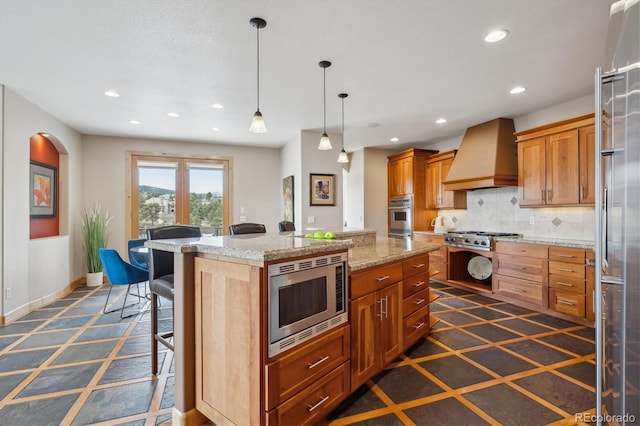 156 S Lookout Mountain Rd, Golden, CO 80401 - kitchen featuring custom range hood, stainless steel appliances, a center island, recessed lighting, and a kitchen bar