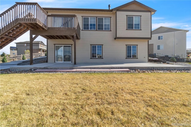 rear view of house featuring a patio area and a yard