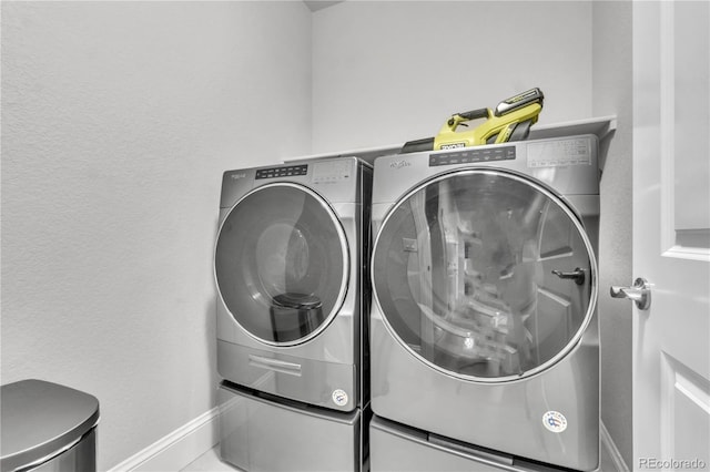 clothes washing area featuring washer and dryer