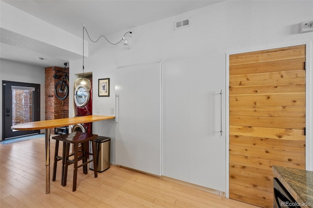 dining space with visible vents and light wood finished floors