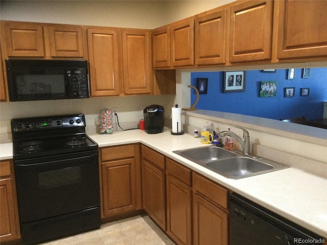 kitchen with sink, light tile patterned floors, and black appliances