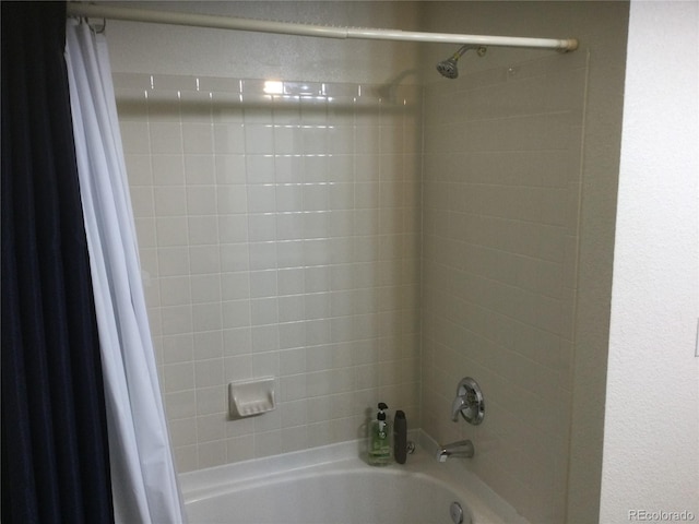 bathroom with shower / bath combo with shower curtain