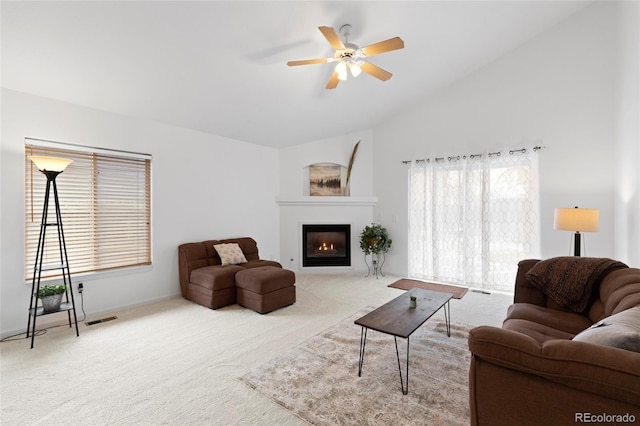 living room featuring carpet, lofted ceiling, and ceiling fan