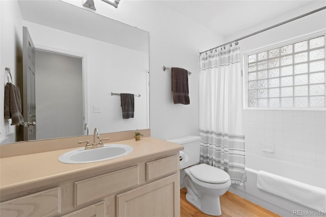 full bathroom featuring toilet, shower / bath combo, wood-type flooring, and vanity