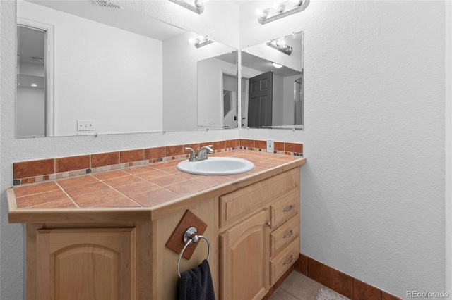 bathroom with vanity and tile patterned flooring