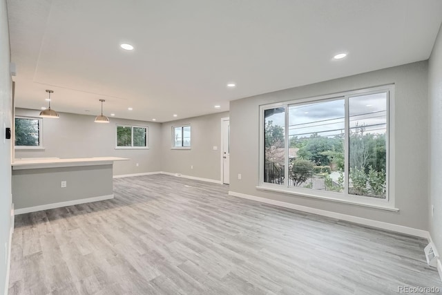 unfurnished living room featuring light wood-type flooring