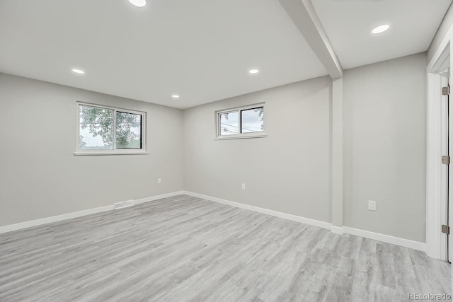 basement featuring plenty of natural light and light wood-type flooring