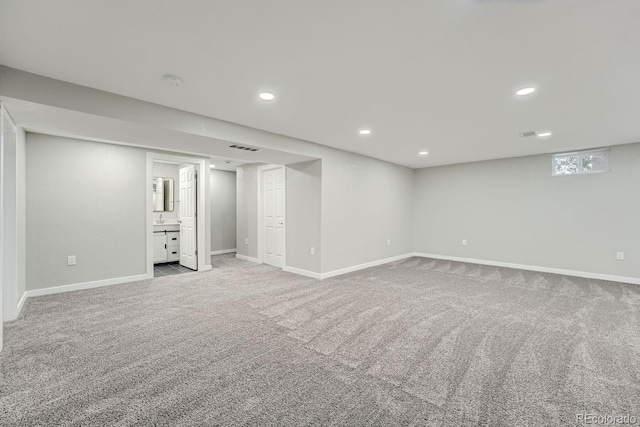 basement featuring light colored carpet