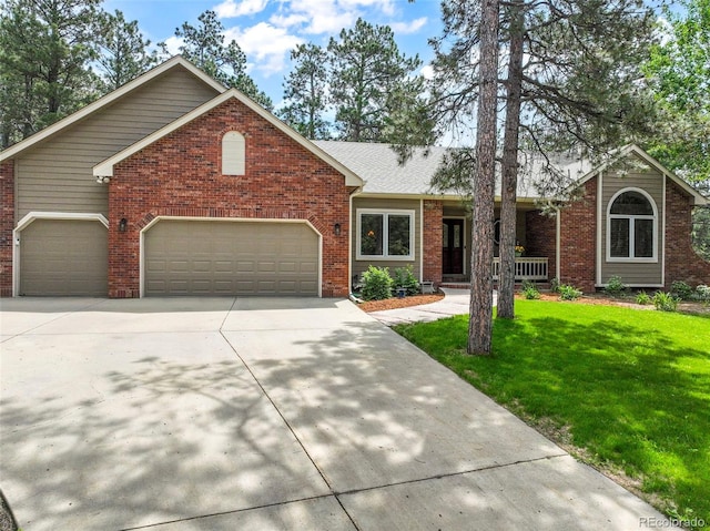 19165 Golden Arrow Cir, Monument, CO 80132 - view of front of home with driveway, a garage, a front yard, and brick siding