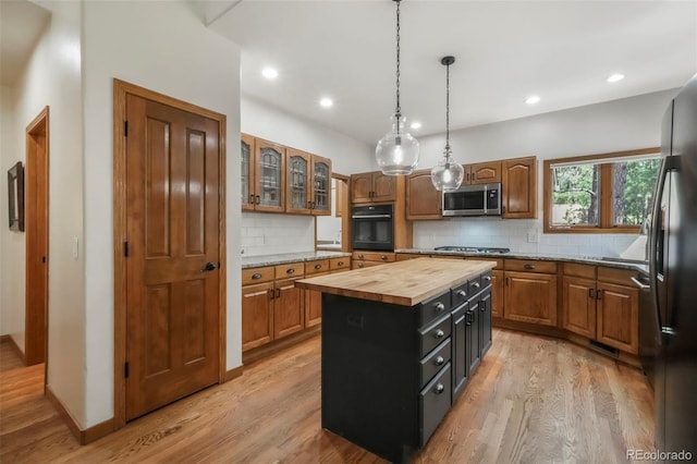 19165 Golden Arrow Cir, Monument, CO 80132 - kitchen featuring black appliances, wooden counters, light wood finished floors, backsplash, and recessed lighting