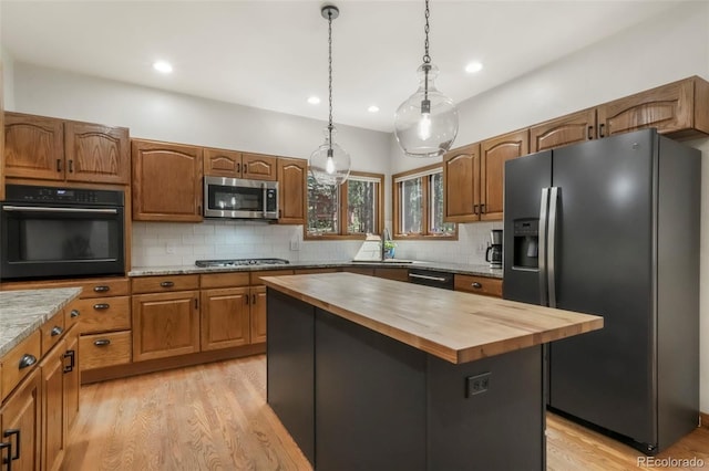 19165 Golden Arrow Cir, Monument, CO 80132 - kitchen featuring fridge with ice dispenser, oven, butcher block countertops, stainless steel microwave, and light wood-style floors