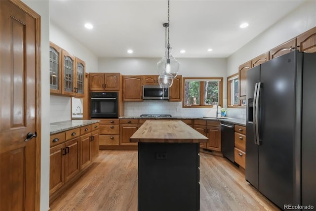 19165 Golden Arrow Cir, Monument, CO 80132 - kitchen with refrigerator with ice dispenser, stainless steel microwave, oven, dishwasher, and wood counters