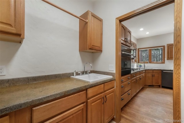 19165 Golden Arrow Cir, Monument, CO 80132 - kitchen featuring dishwashing machine, recessed lighting, light wood finished floors, decorative backsplash, and brown cabinetry