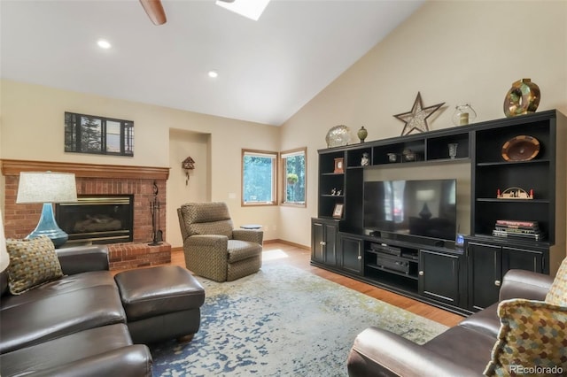 19165 Golden Arrow Cir, Monument, CO 80132 - living area featuring light wood-type flooring, vaulted ceiling, a fireplace, recessed lighting, and ceiling fan