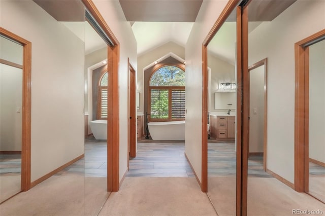 19165 Golden Arrow Cir, Monument, CO 80132 - hall featuring light colored carpet and vaulted ceiling
