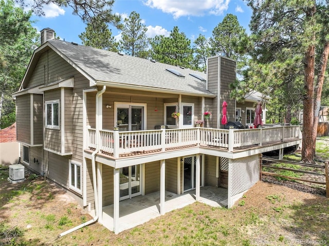 19165 Golden Arrow Cir, Monument, CO 80132 - back of house featuring a chimney, a patio area, a deck, and roof with shingles