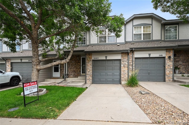 2085 E 103rd Ave, Thornton, CO 80229 - multi unit property featuring stone siding, stucco siding, driveway, and a garage
