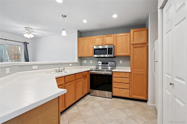 2085 E 103rd Ave, Thornton, CO 80229 - kitchen with appliances with stainless steel finishes, light countertops, light tile patterned floors, decorative light fixtures, and ceiling fan