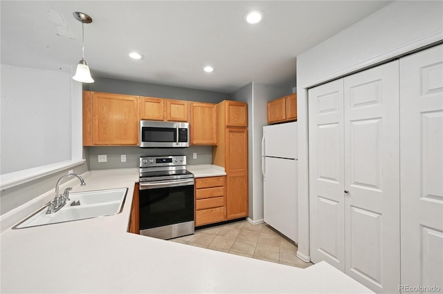 2085 E 103rd Ave, Thornton, CO 80229 - kitchen with appliances with stainless steel finishes, light countertops, light tile patterned floors, recessed lighting, and decorative light fixtures