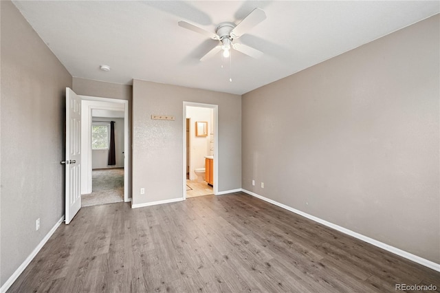 2085 E 103rd Ave, Thornton, CO 80229 - unfurnished bedroom featuring wood finished floors, connected bathroom, and ceiling fan