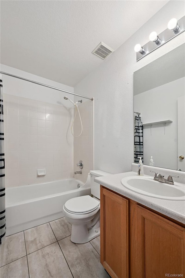 2085 E 103rd Ave, Thornton, CO 80229 - bathroom featuring shower / bathtub combination with curtain, vanity, tile patterned flooring, and a textured ceiling