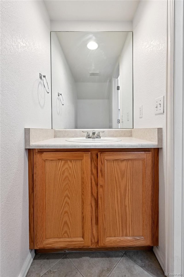 2085 E 103rd Ave, Thornton, CO 80229 - bathroom featuring vanity, tile patterned floors, and a textured wall