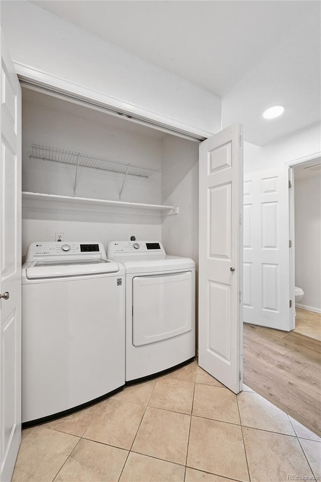 2085 E 103rd Ave, Thornton, CO 80229 - washroom with washing machine and clothes dryer and light tile patterned floors