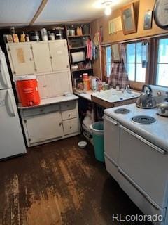 kitchen featuring white appliances, open shelves, dark wood-style flooring, and light countertops