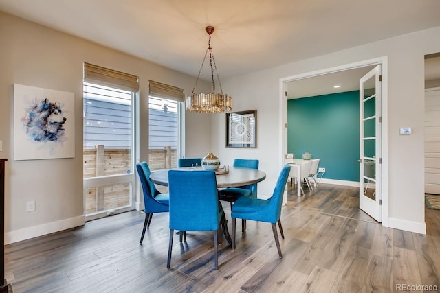 dining space with a chandelier and hardwood / wood-style flooring