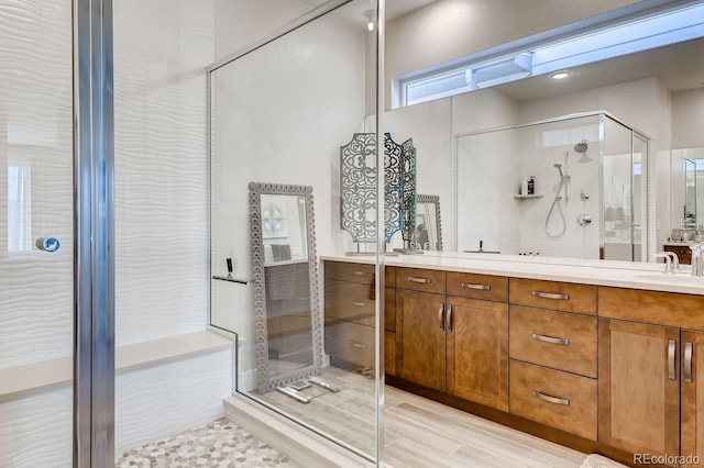 bathroom featuring hardwood / wood-style flooring, vanity, and an enclosed shower