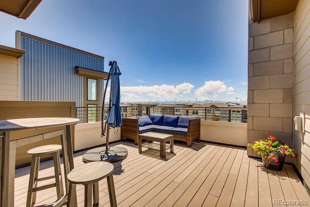 wooden deck with an outdoor living space