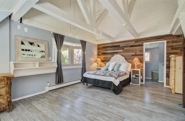 bedroom with a baseboard radiator, wooden walls, wood finished floors, and baseboards