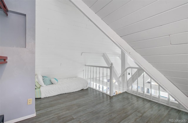 bonus room with wood finished floors and baseboards
