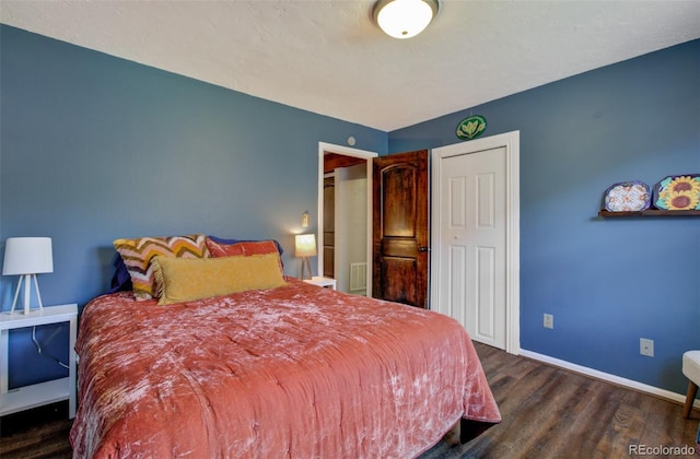 bedroom featuring wood finished floors and baseboards