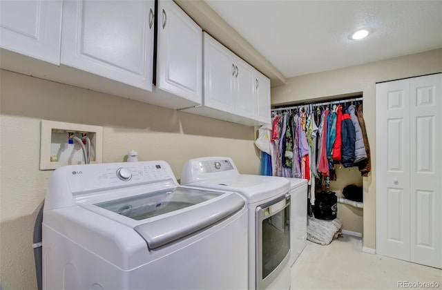 laundry room featuring cabinet space, washing machine and clothes dryer, and recessed lighting