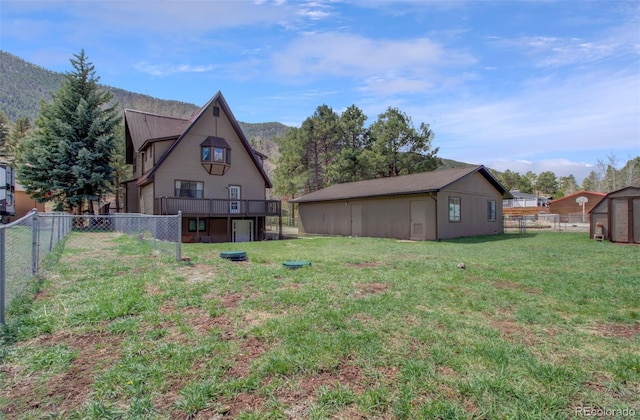 rear view of property with an outdoor structure and a storage unit