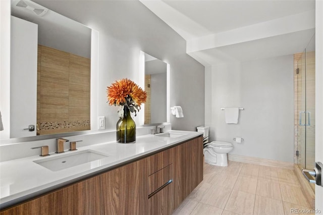 bathroom featuring tile patterned flooring, vanity, toilet, and a shower with door