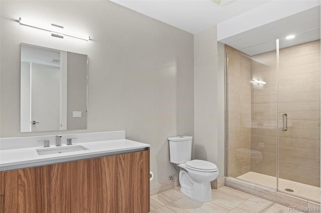 bathroom featuring walk in shower, vanity, and toilet