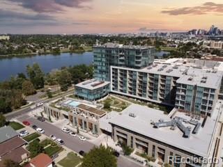 aerial view at dusk featuring a water view