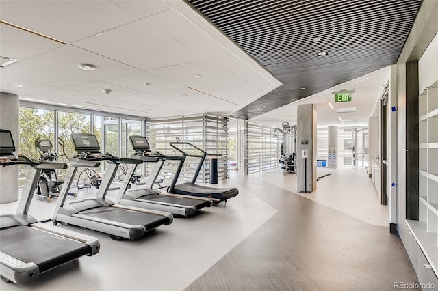 gym with a wall of windows