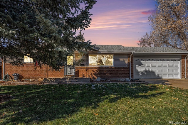 view of front of home with a lawn and a garage