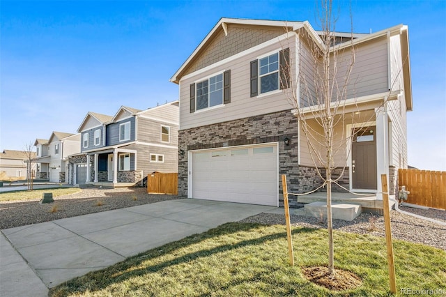 view of front of property with fence, a residential view, a garage, stone siding, and driveway