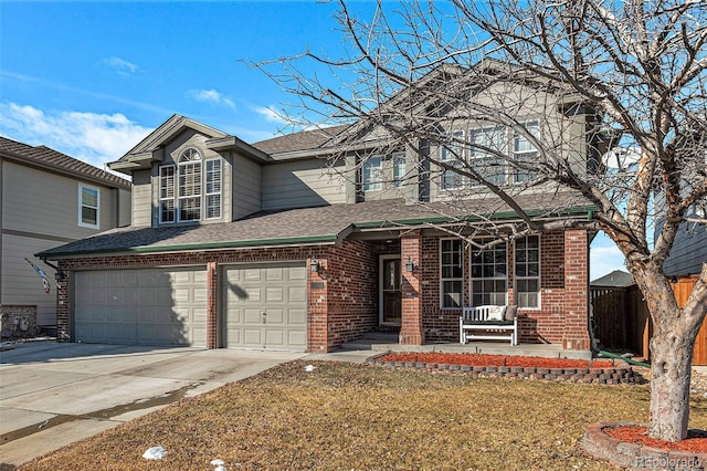 view of property with covered porch, a front yard, and a garage