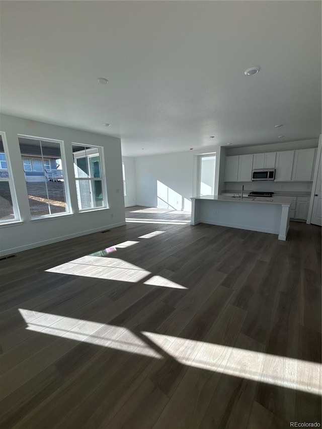 unfurnished living room featuring dark hardwood / wood-style flooring