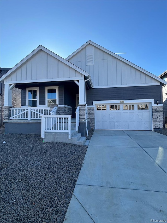 view of front of property featuring covered porch and a garage