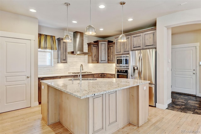5080 Uinta St, Denver, CO 80238 - kitchen featuring wall chimney exhaust hood, appliances with stainless steel finishes, light wood-style floors, light stone countertops, and recessed lighting