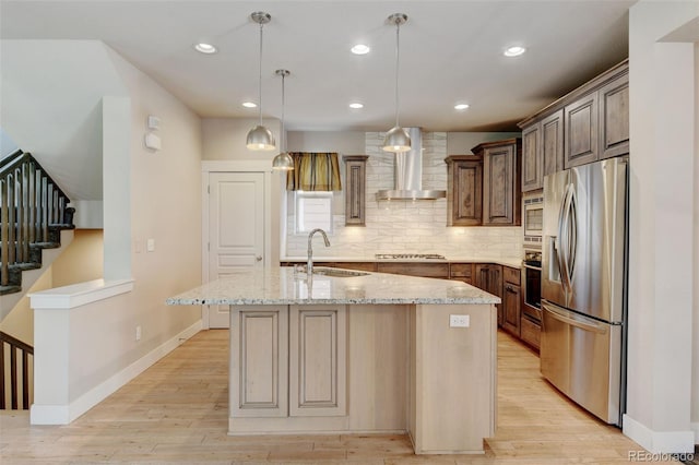 5080 Uinta St, Denver, CO 80238 - kitchen featuring stainless steel appliances, wall chimney range hood, decorative backsplash, light wood-type flooring, and light stone counters