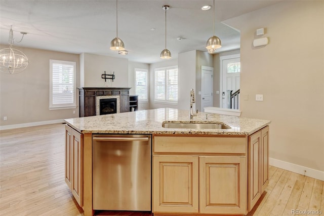 5080 Uinta St, Denver, CO 80238 - kitchen with dishwasher, light wood-style flooring, an island with sink, open floor plan, and light stone countertops