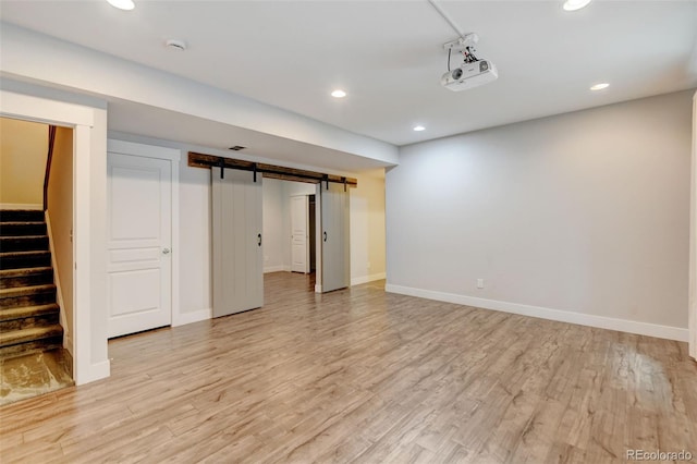 5080 Uinta St, Denver, CO 80238 - finished below grade area with recessed lighting, light wood finished floors, a barn door, and stairs