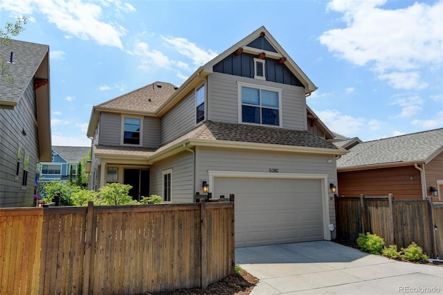 5080 Uinta St, Denver, CO 80238 - view of front facade with board and batten siding, driveway, a garage, and a shingled roof
